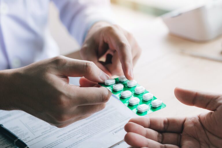 Doctor is pointing to drug tablet and introducing the properties of the painkiller to patient