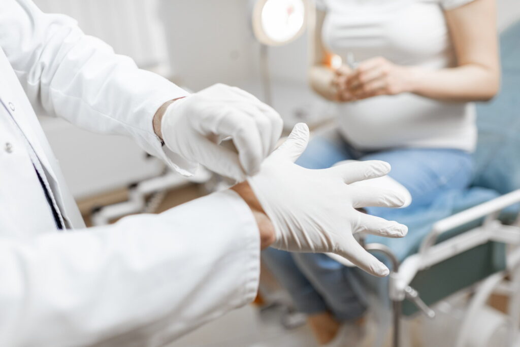 Doctor wearing medical gloves before a procedure