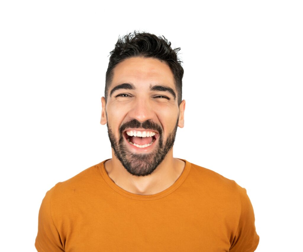 Young man smiling against white background.
