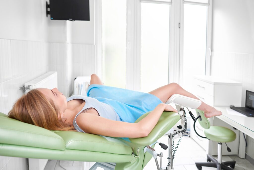 Professional gynecologist examining her patient