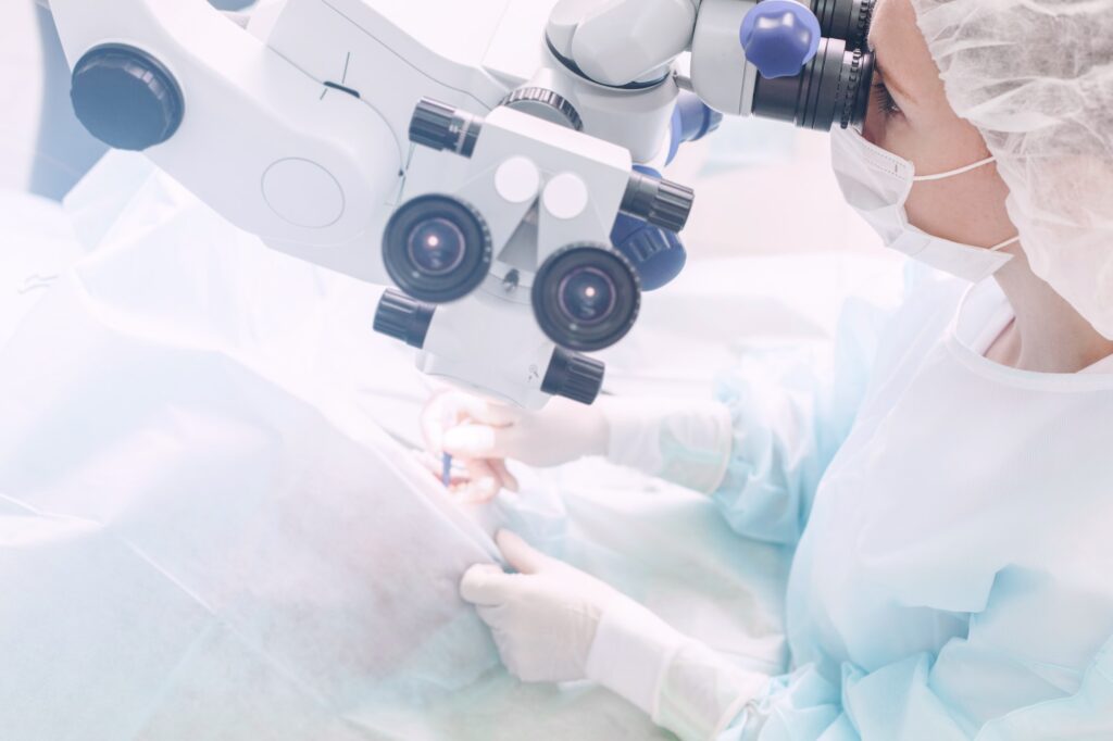 Surgeon performing an eye surgery under the microscope. Eyesight correction. doctor in operation