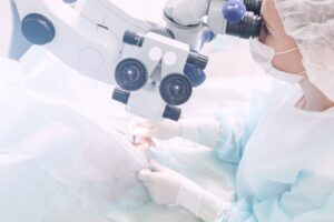 Surgeon performing an eye surgery under the microscope. Eyesight correction. doctor in operation