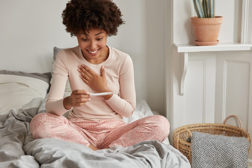 It wil be start of new life! Cheerful African American future mother cant believe in positive result