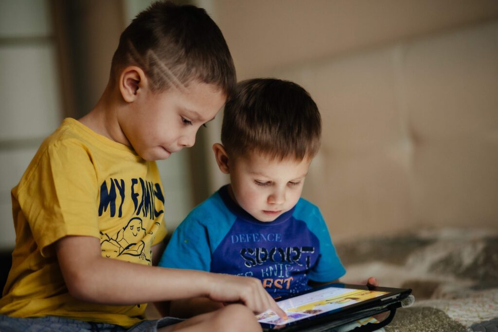 Children playing on tablet at home
