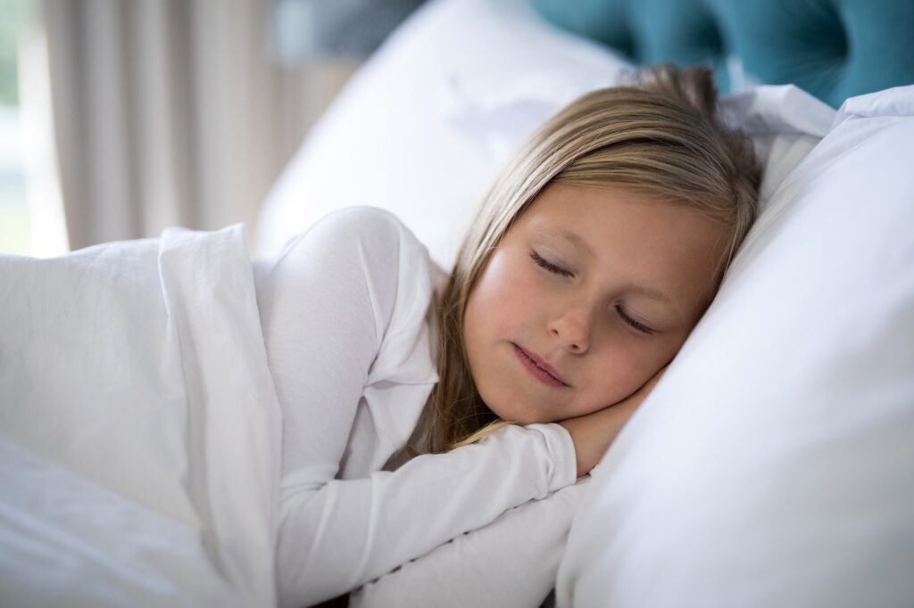 Girl sleeping on bed in bedroom