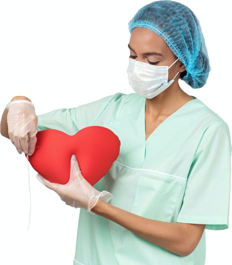 a woman in surgery holding a heart in her hands