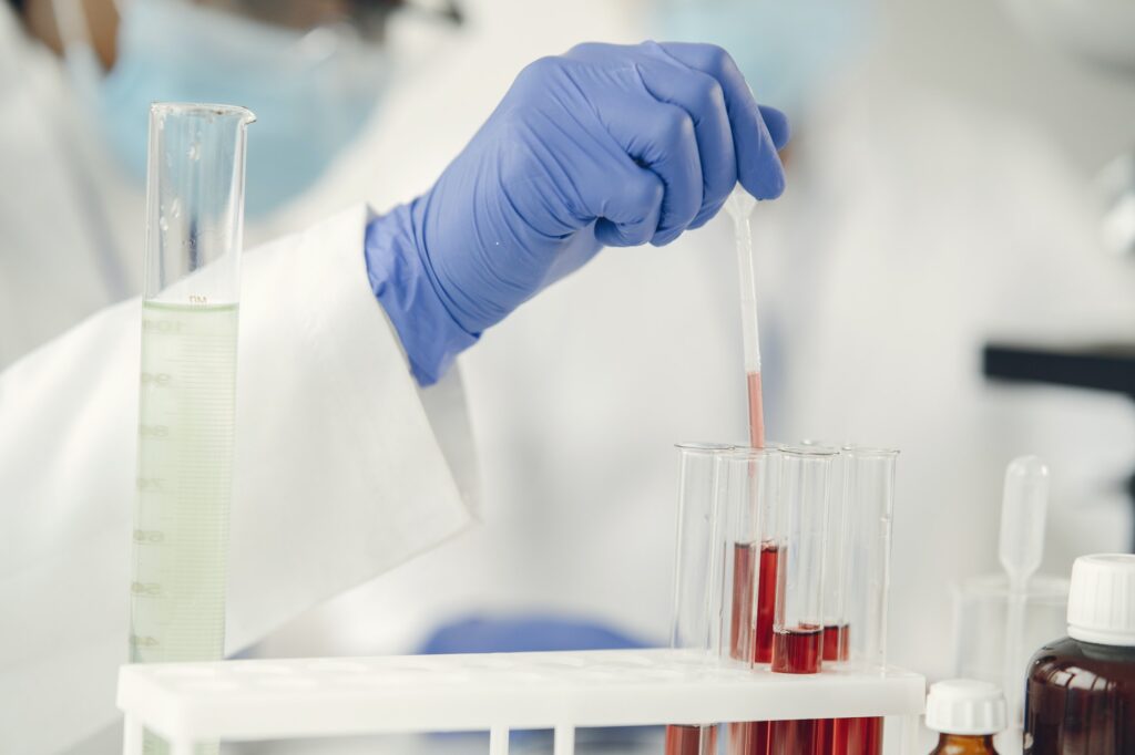 Laboratory worker studying blood samples to detect pathologies