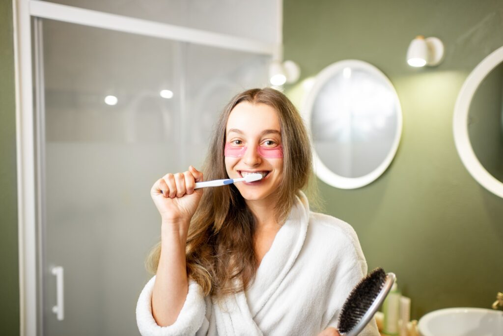 Woman brushhing teeth in the bathroom