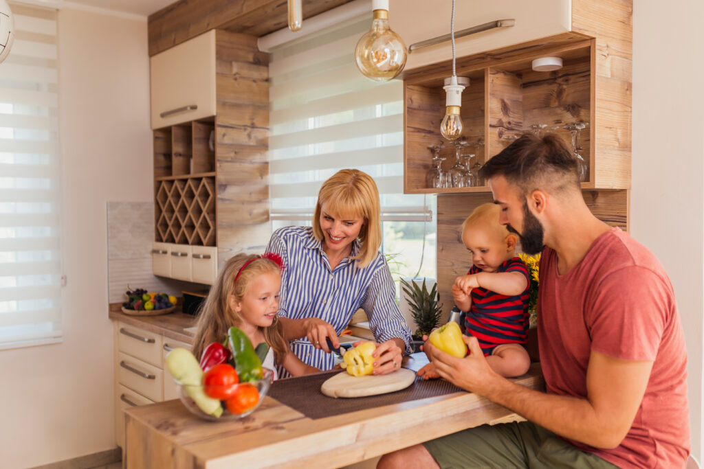 Mother and father preparing food with their children