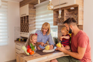 Mother and father preparing food with their children