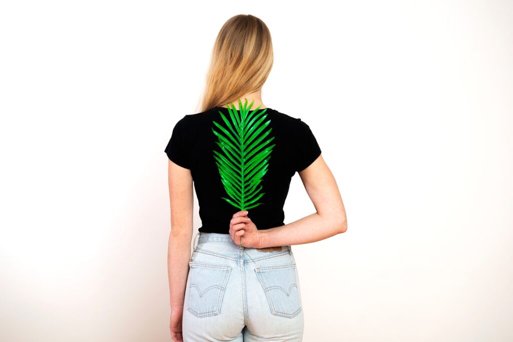 Green fern on female back,spine and woman health concept