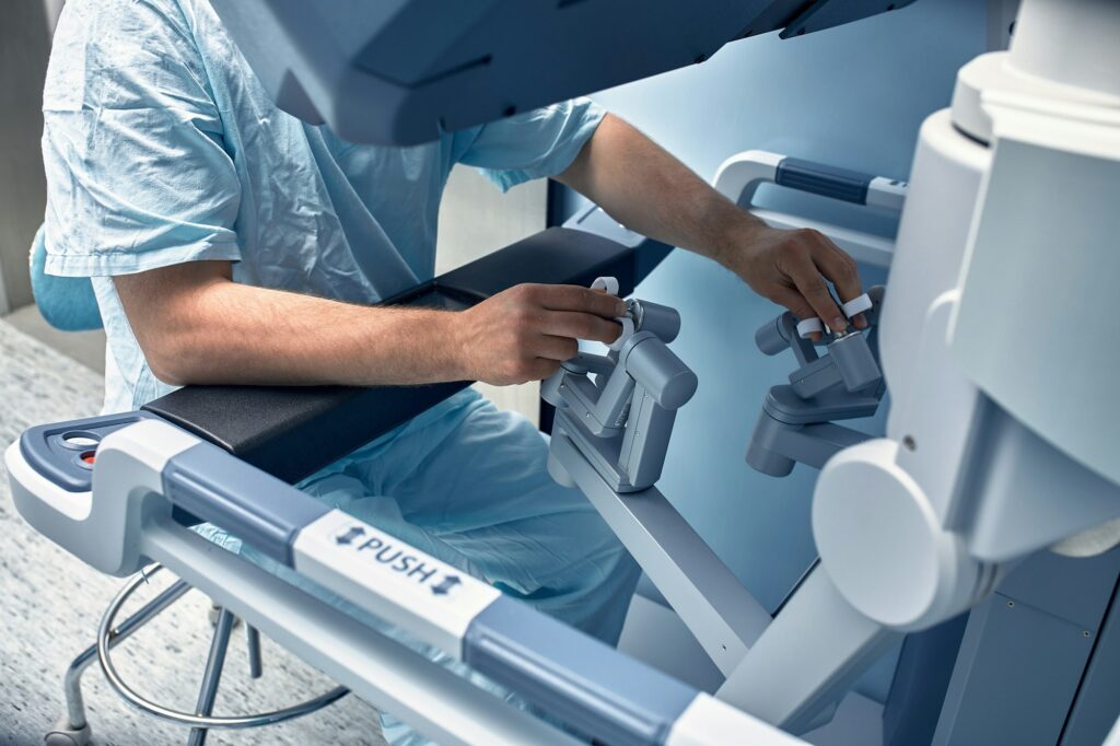 Hands of a surgeon at a computer robot. medical robot. Robotic Surgery.