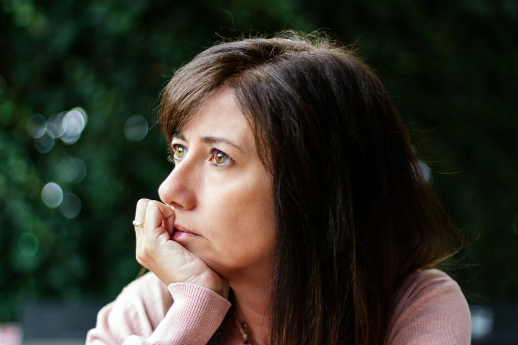 Woman thinking with the hand in the face