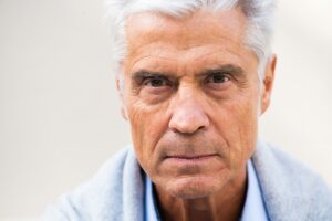 Close up serious older man eyes looking
