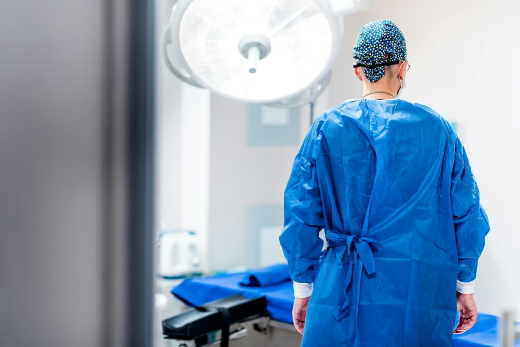 Portrait of surgeon in operating room of hospital. Getting ready for surgery