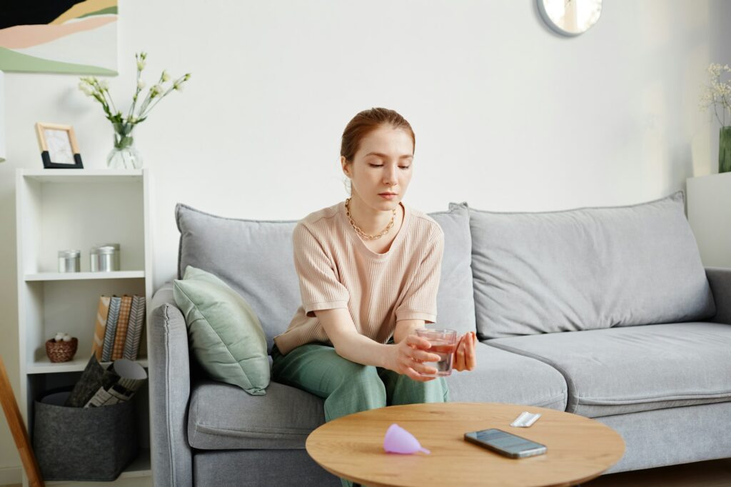 Young Woman Taking Pain Medication