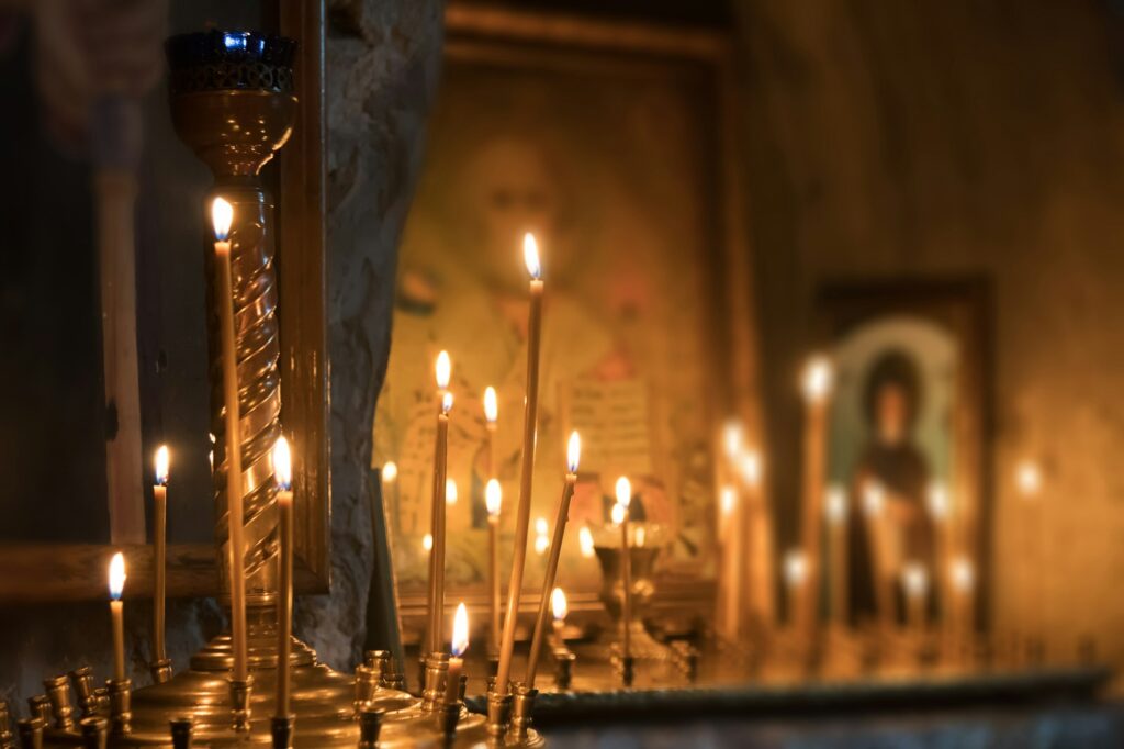Icons and burning candles in the church