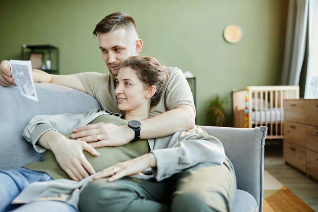 Couple looking at ultrasound scan of baby