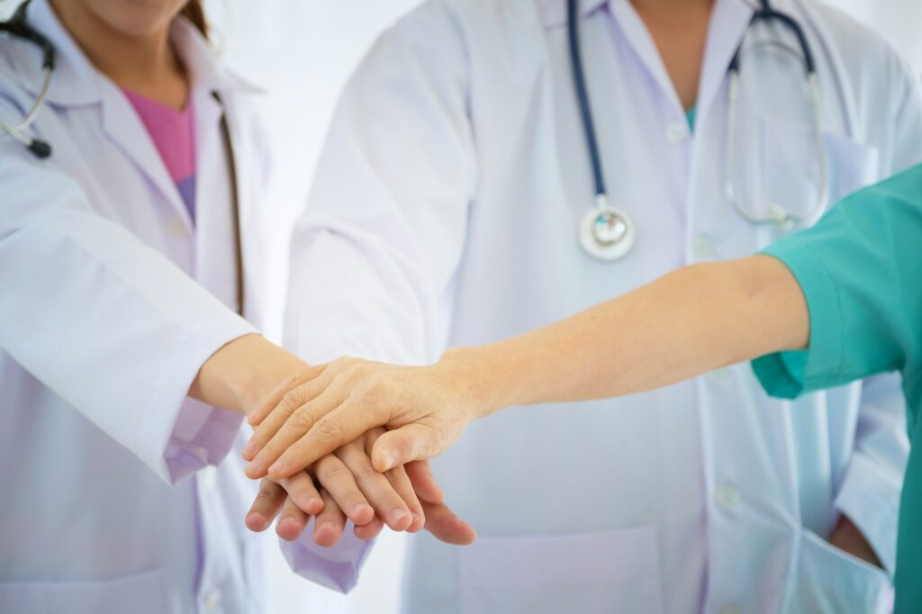 Teamwork concept, doctors thumb up together at hospital.