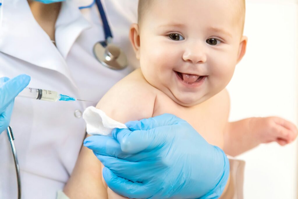 Vaccination of a baby by a doctor in a hospital. Selective focus.