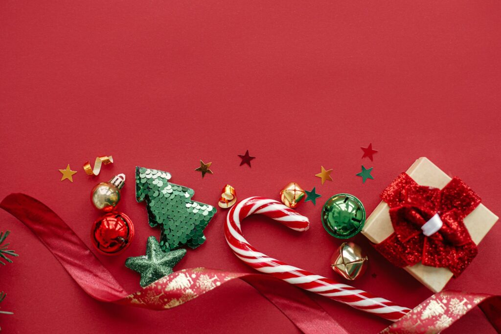 Merry Christmas and Happy Holidays! Modern christmas gift, candy cane, decorations flat lay