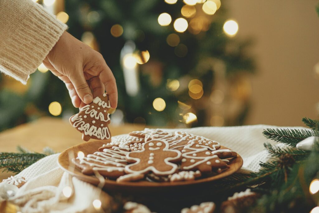 Merry Christmas! Hand holding gingerbread cookie with icing