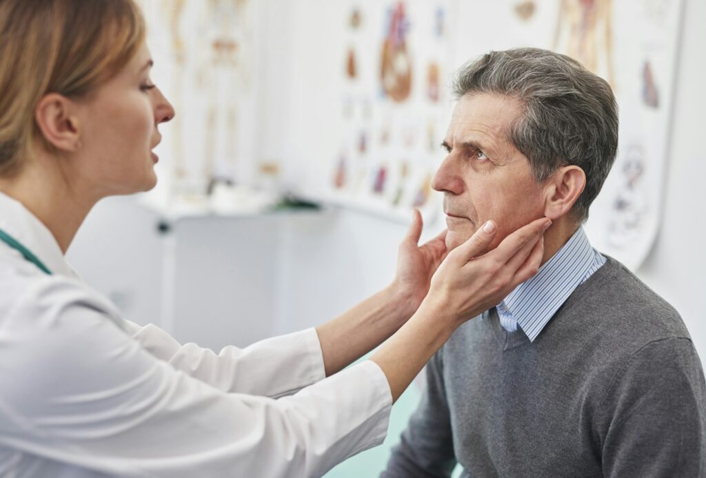 Senior man during routine examination at the doctor