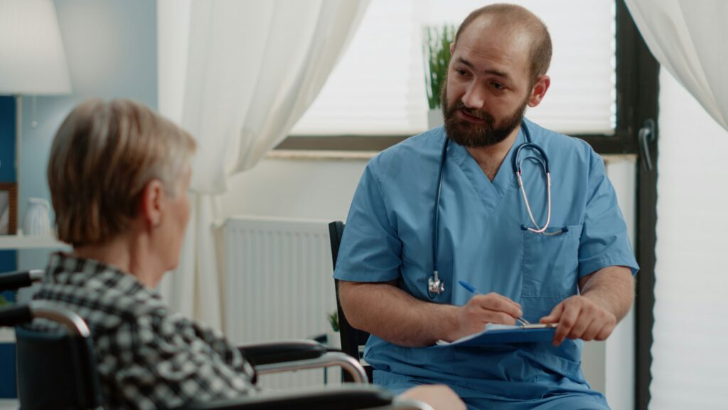 Senior patient with chronic issues talking to nurse about treatment