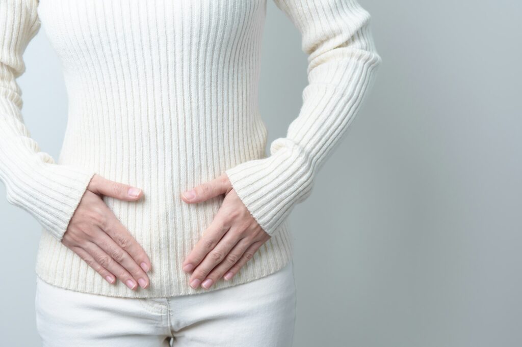 Woman holding her belly. Pregnancy, Reproductive system, menstruation, and gynecology concept