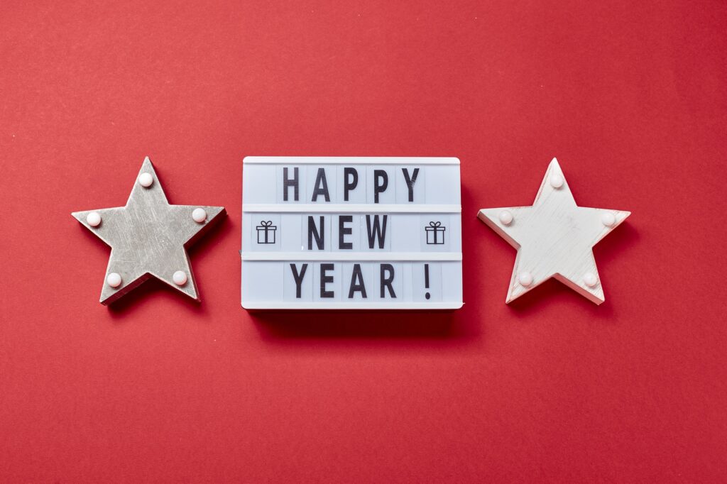 Light box inscription Happy New Year and wooden decorations