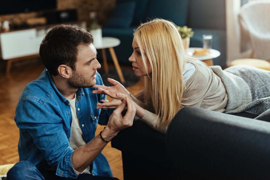 Young couple discussing about problems in their relationship at home.
