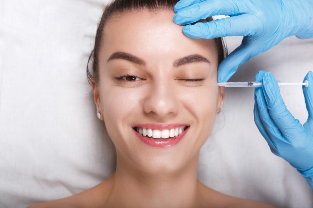 Facial Beauty Injections. Portrait Beautiful Young Woman Receiving Hyaluronic Acid Injection