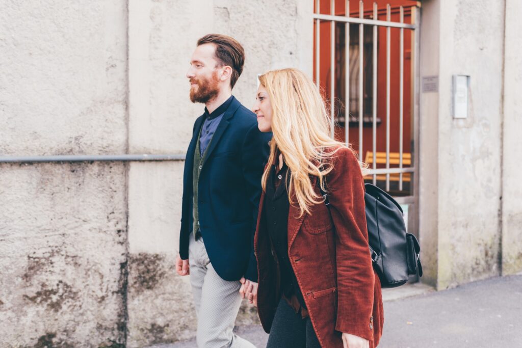 Young couple walking outdoor holding hands